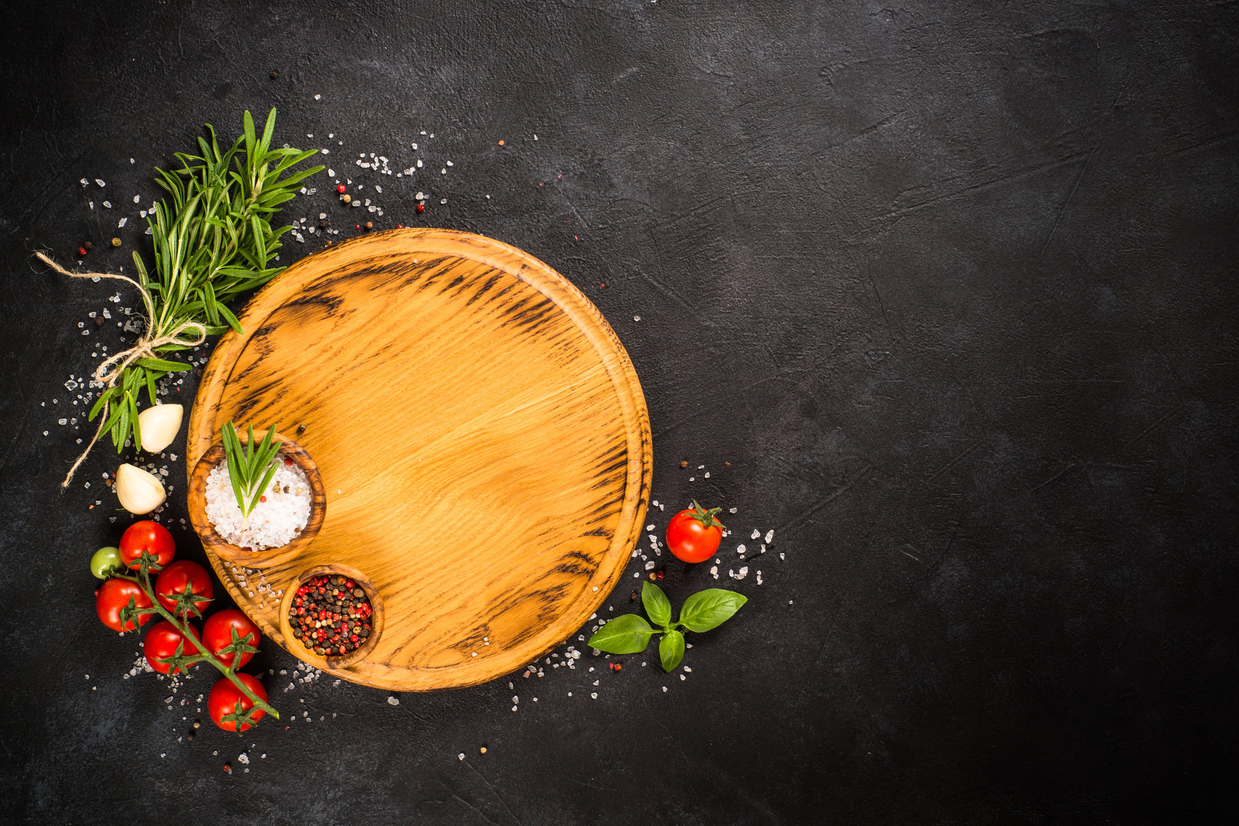 Herbs and Spices with Cutting Board on Black Background 